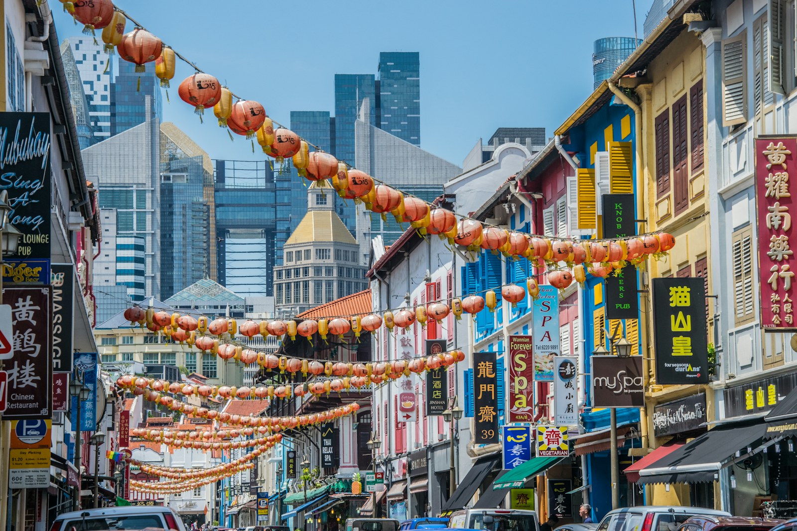 Lantern-lined Chinatown street and shophouses near Chin Swee Road, Singapore, with high-rises beyond