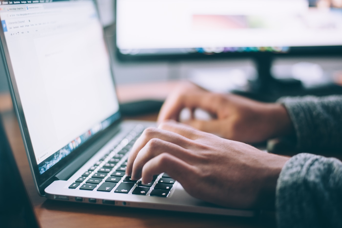 Reviewer working at a laptop while listening to an episode under review